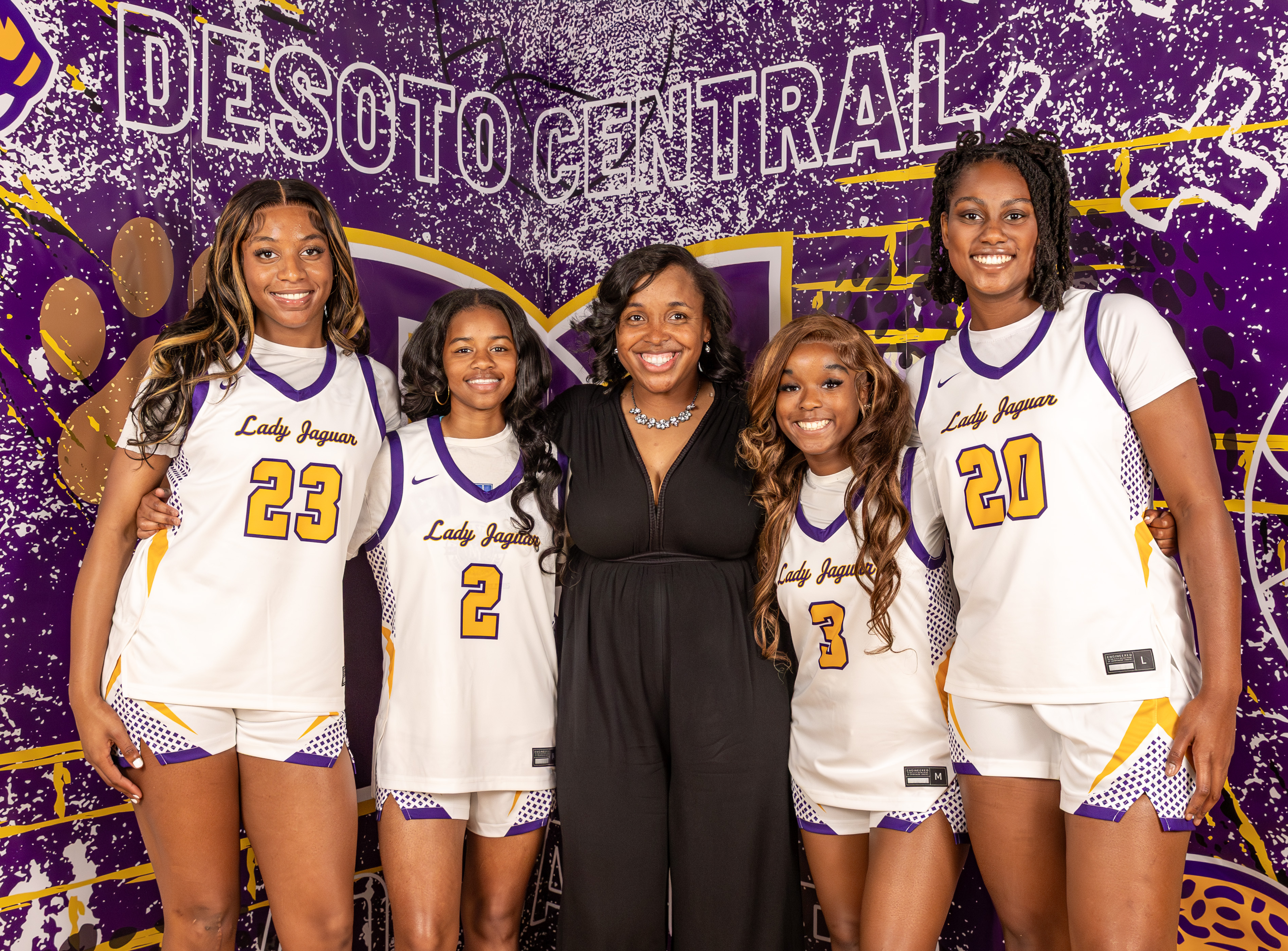 Jamaiya Hasley and Reagan Dale seated in chairs on the basketball court