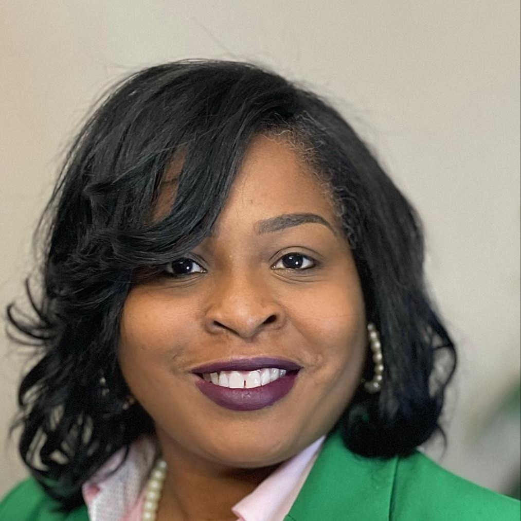 A Head Shot of Sharonda Riley the Counselor Smiling in a Green Blazer 