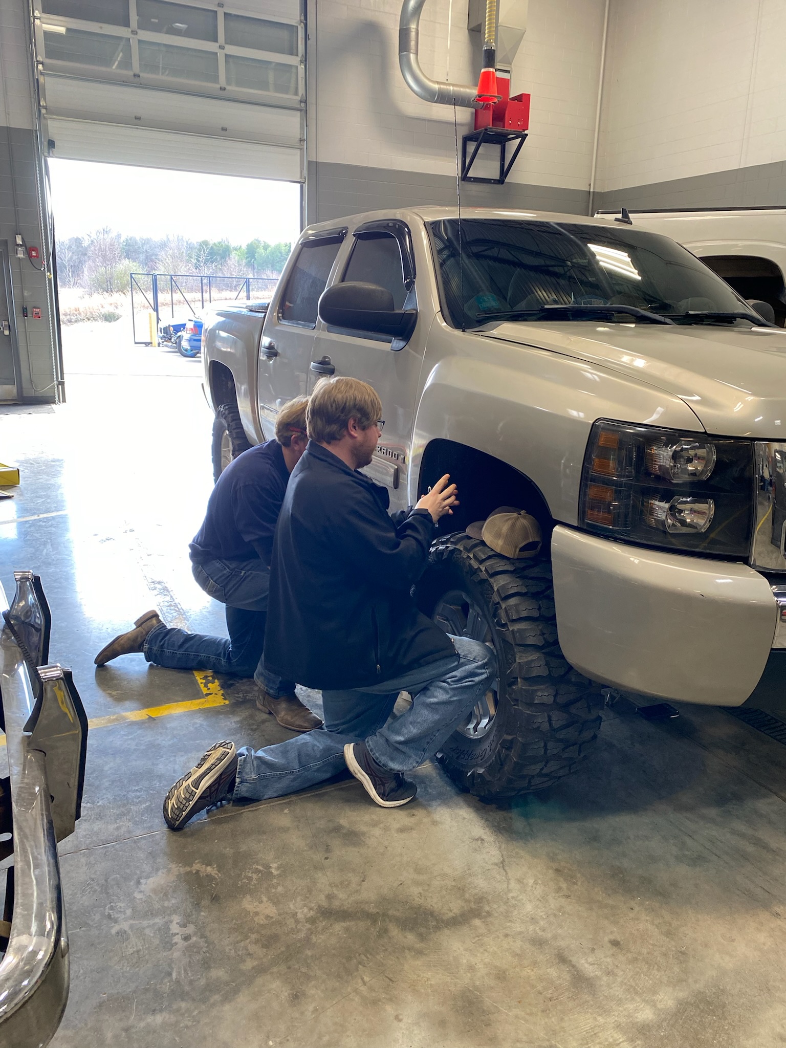 Students working on a truck tire