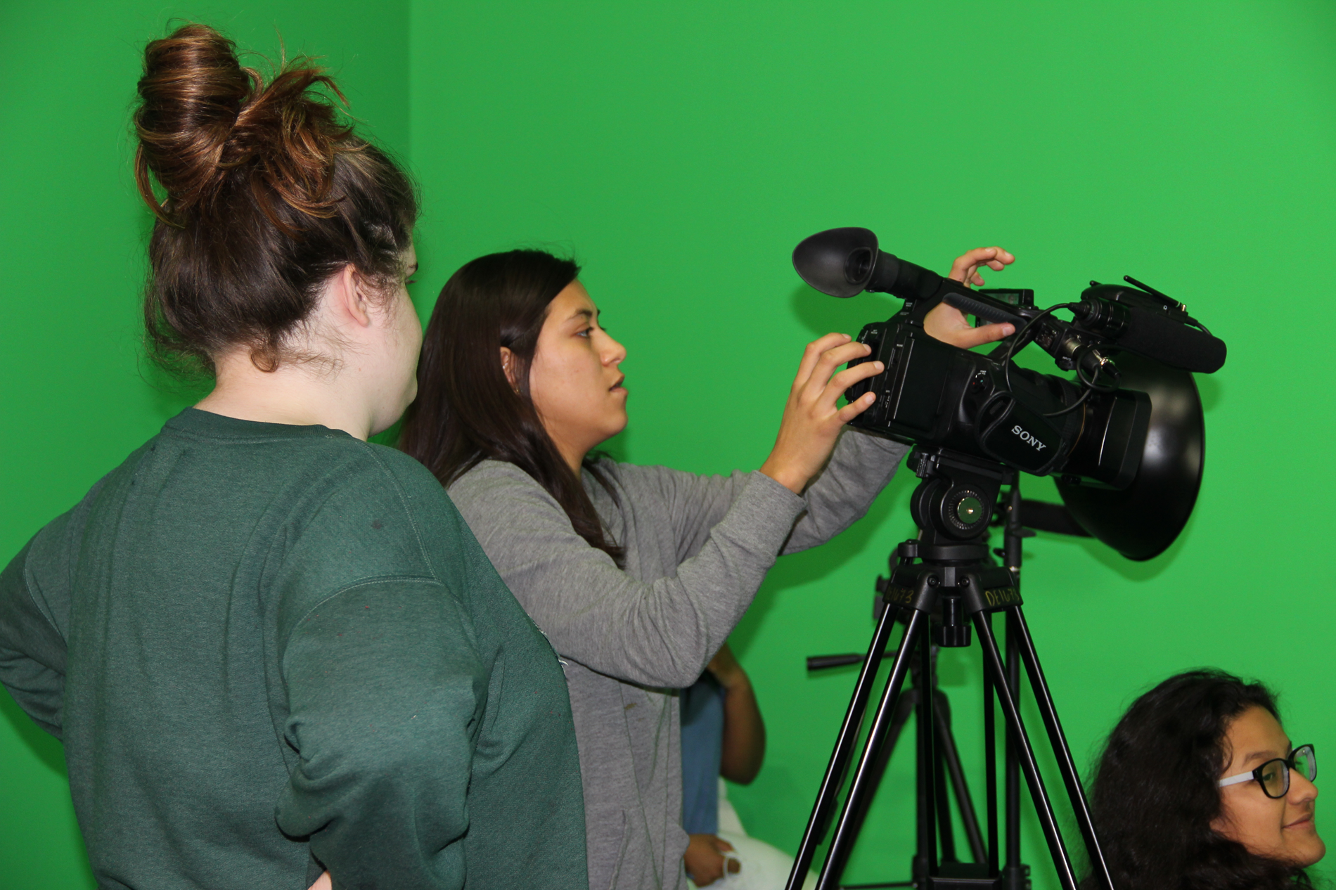 Students working with a green screen