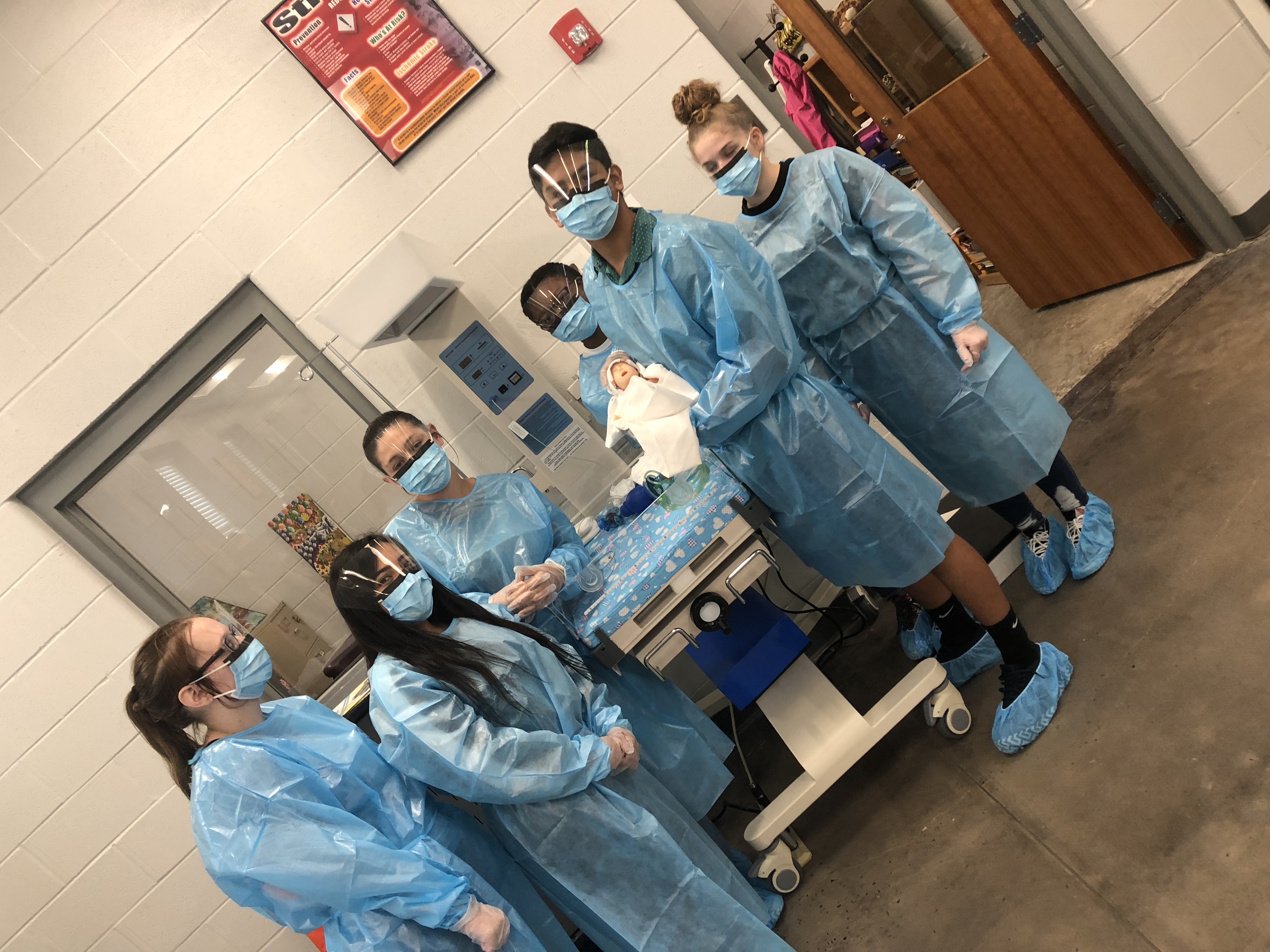 Group of Students in Scrubs posing for picture