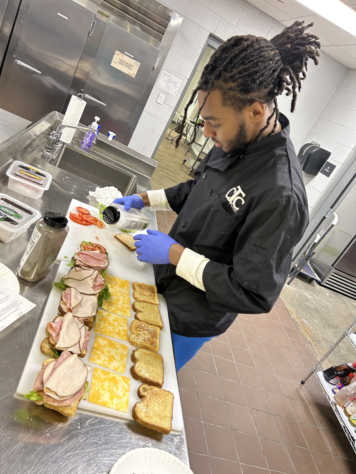 Student pointing at an OPEN sign
