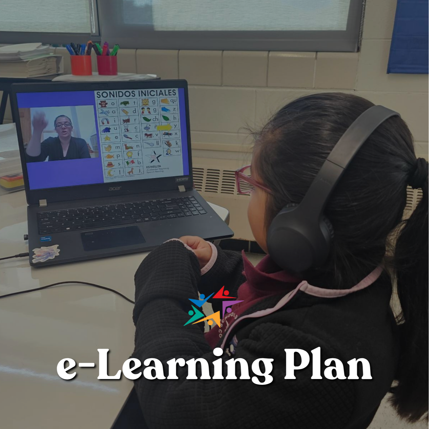 A student wearing headphones follows an e-learning lesson on a laptop, with a teacher video and Spanish initial-sounds chart on screen; focused and calm.