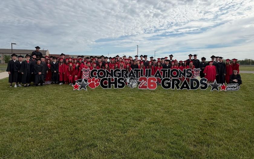 graduates of 2026 pose in front of the school
