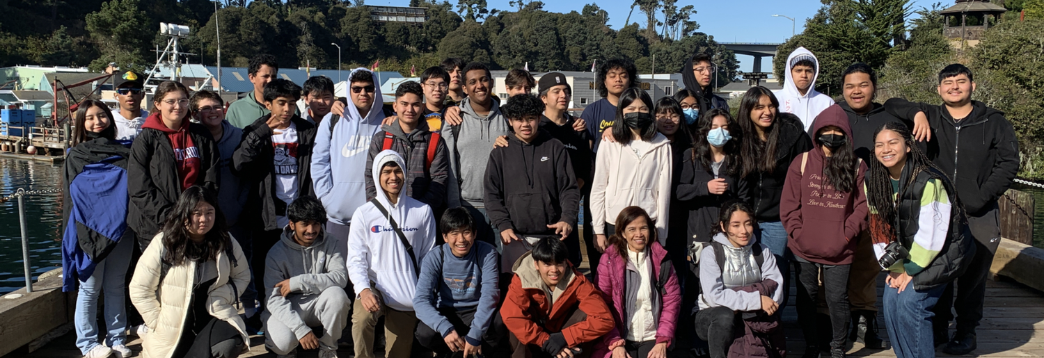 group of students on a dock