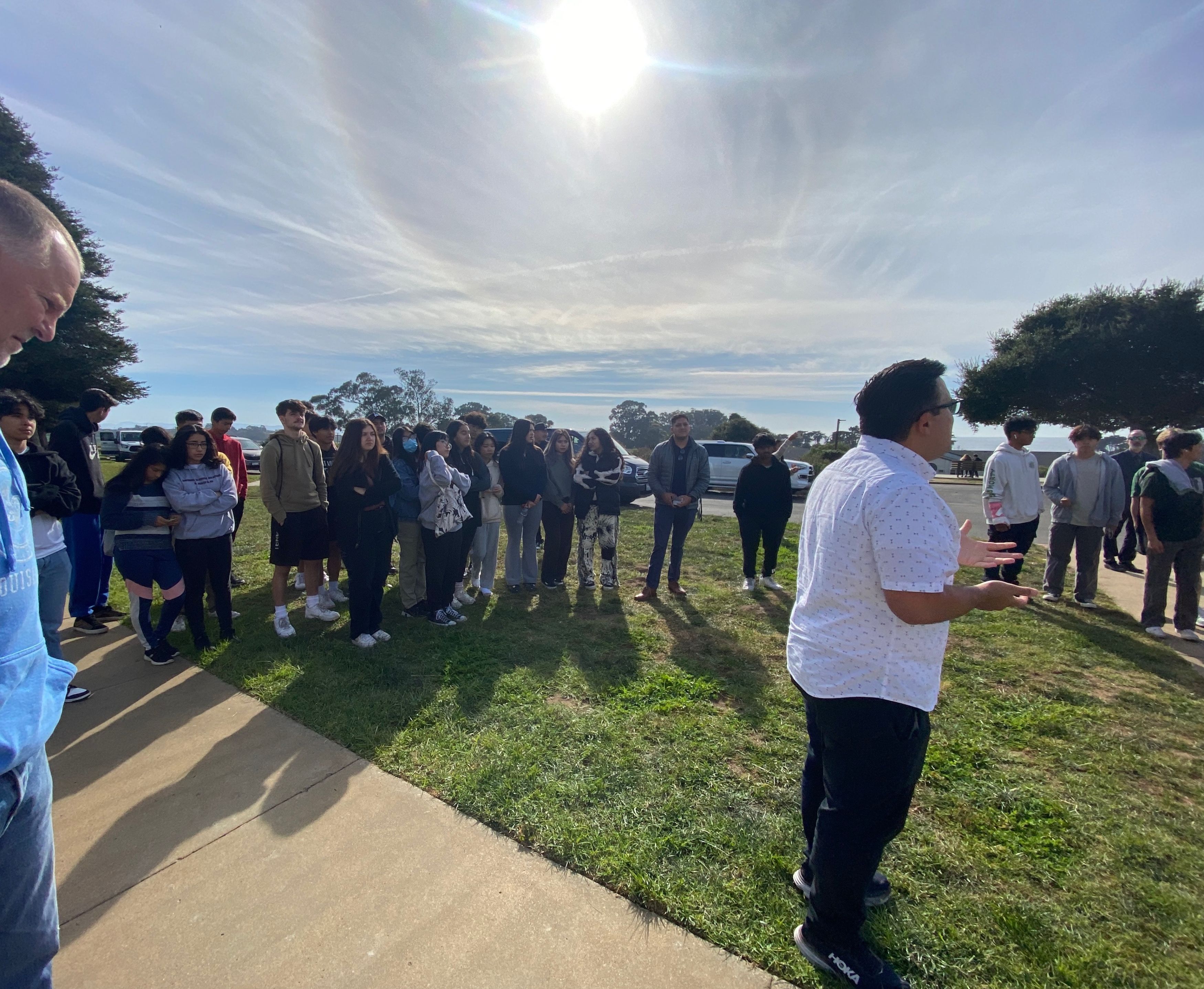 man talking to a group outside