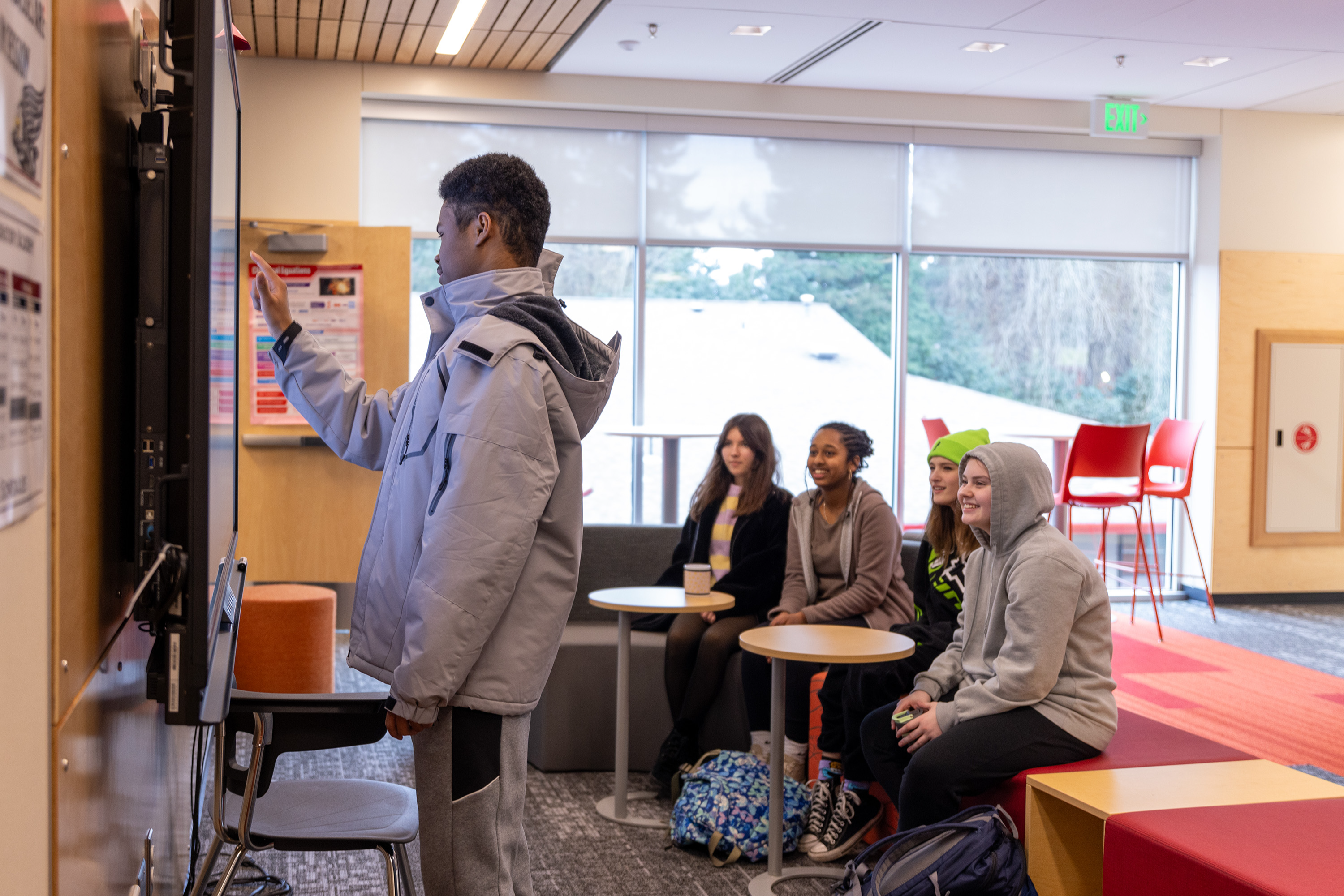 Students using technology and smiling