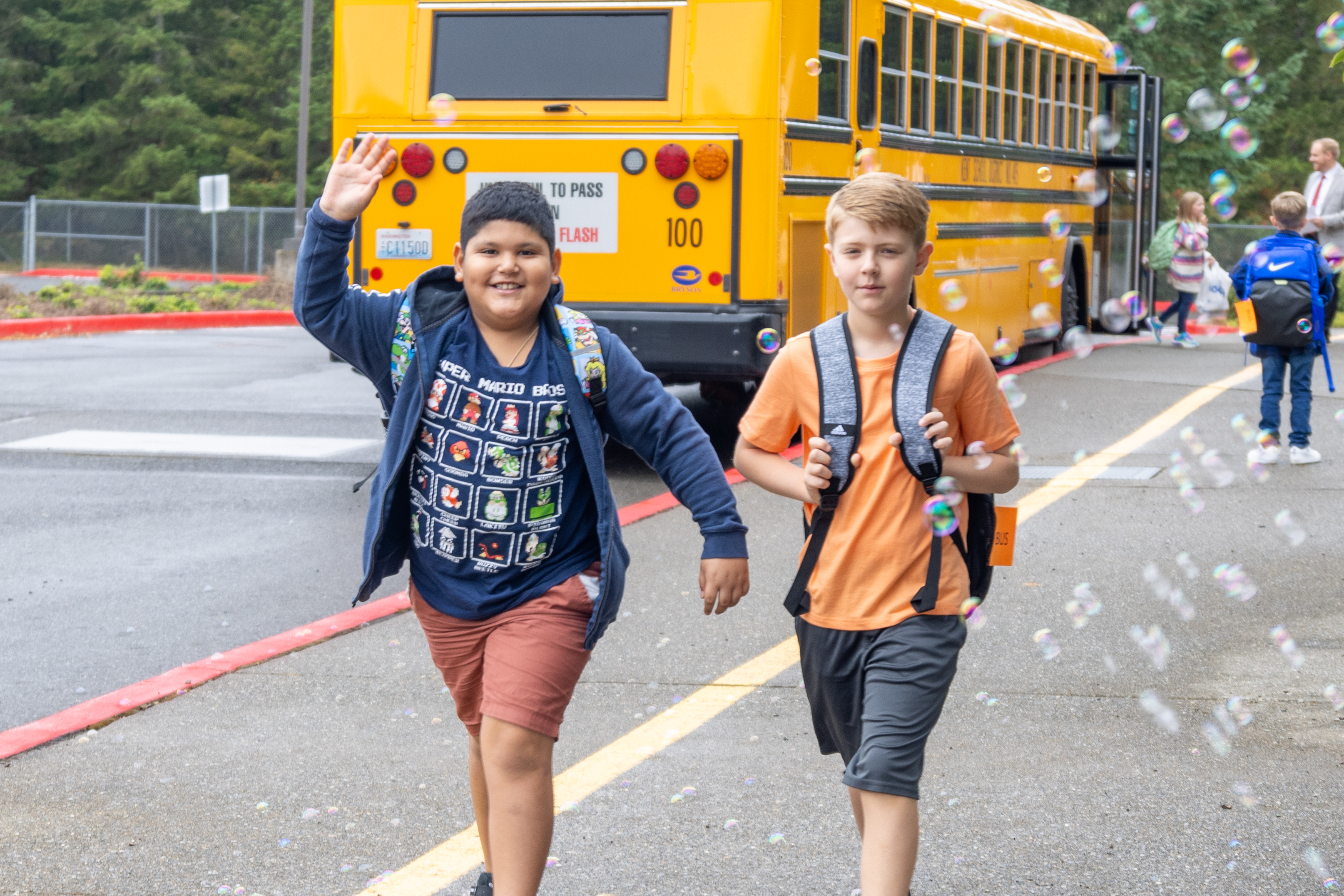 Students waving