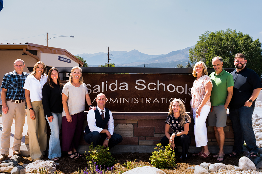 Salida School Board in front of Salida Schools Administration sign at Central Admin Office
