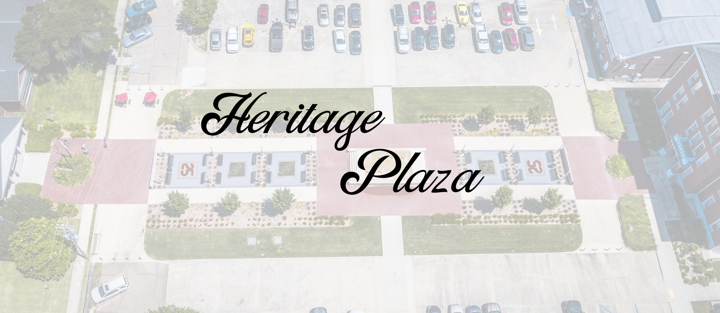 Heritage Plaza text banner with aerial view of heritage plaza in the back ground