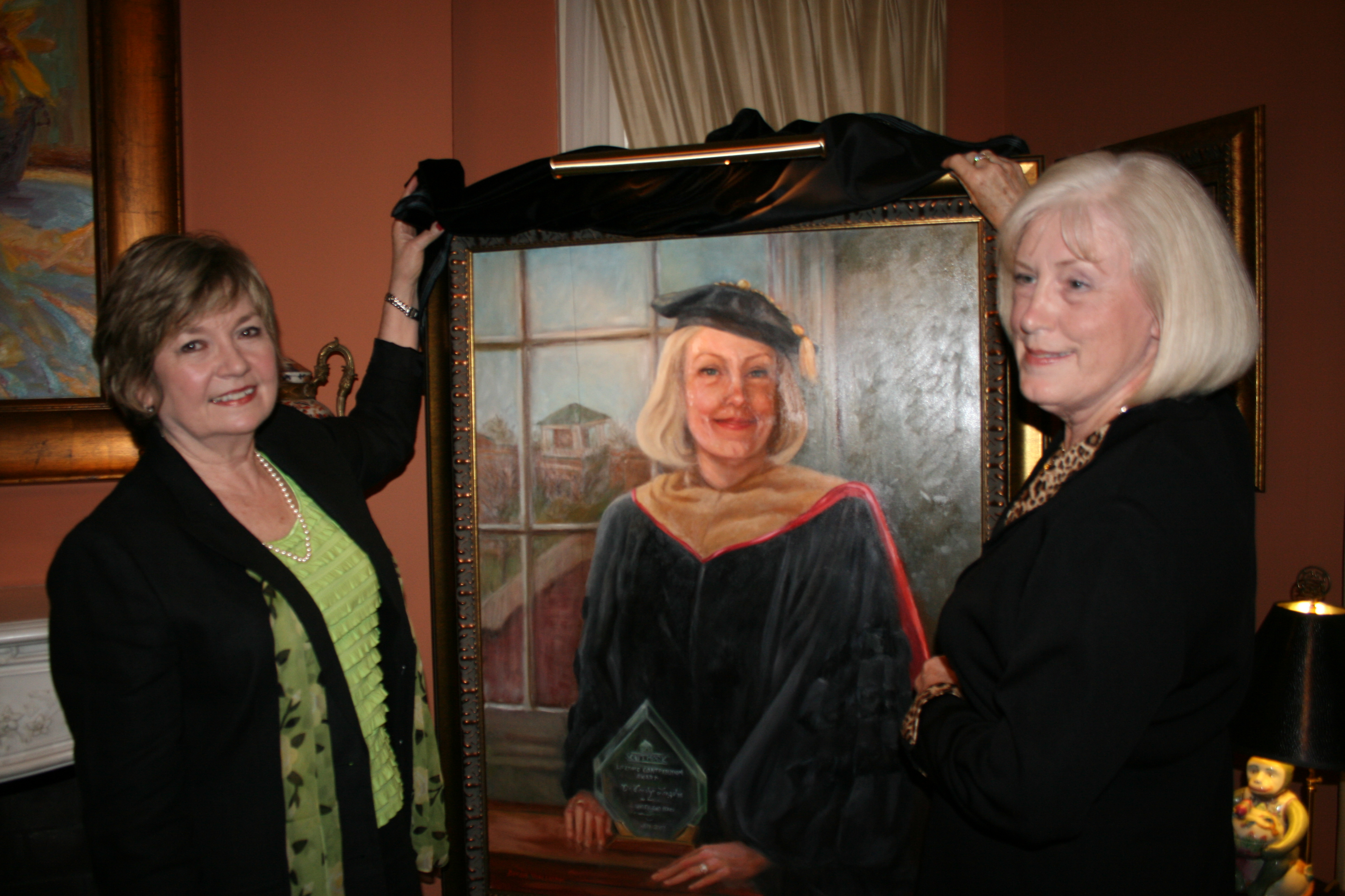 Photo of Dinah Van Hook and Dr. Carolyn Langston unveiling Dr. Langston's portrait.