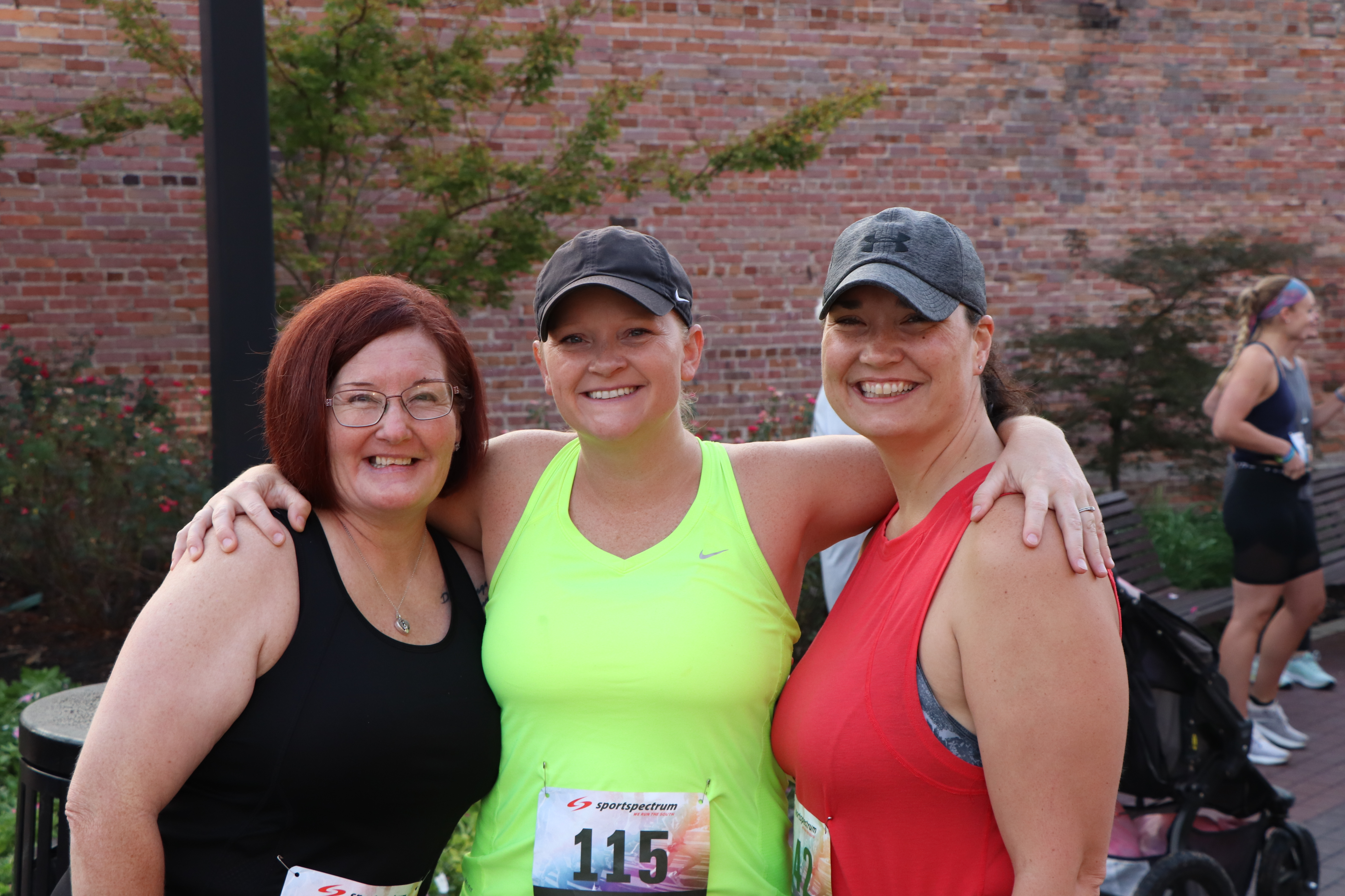 Group photo of 3 women smiling at the Hero 5k at the 2023 Outdoor Expo