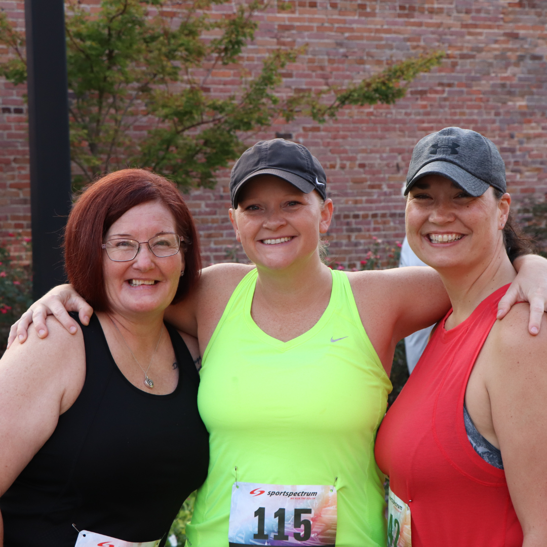 Group photo of 3 women smiling at the Hero 5k at the 2023 Outdoor Expo