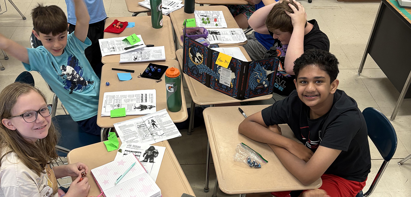 Students at table playing Dungeons and Dragons