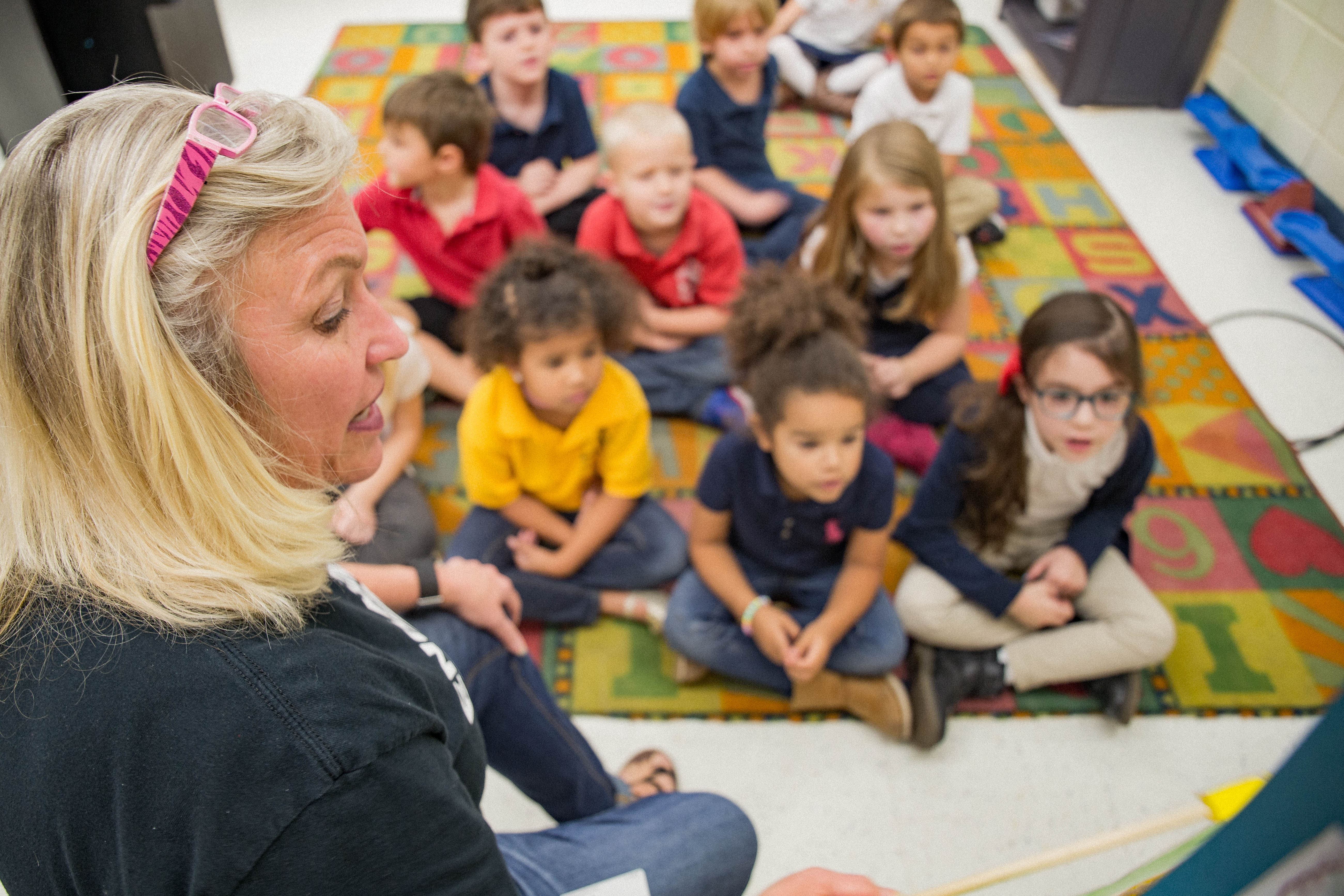 Teacher talking in front of kindergarten students