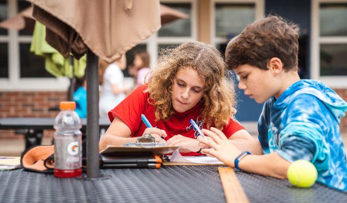 Two students working outside