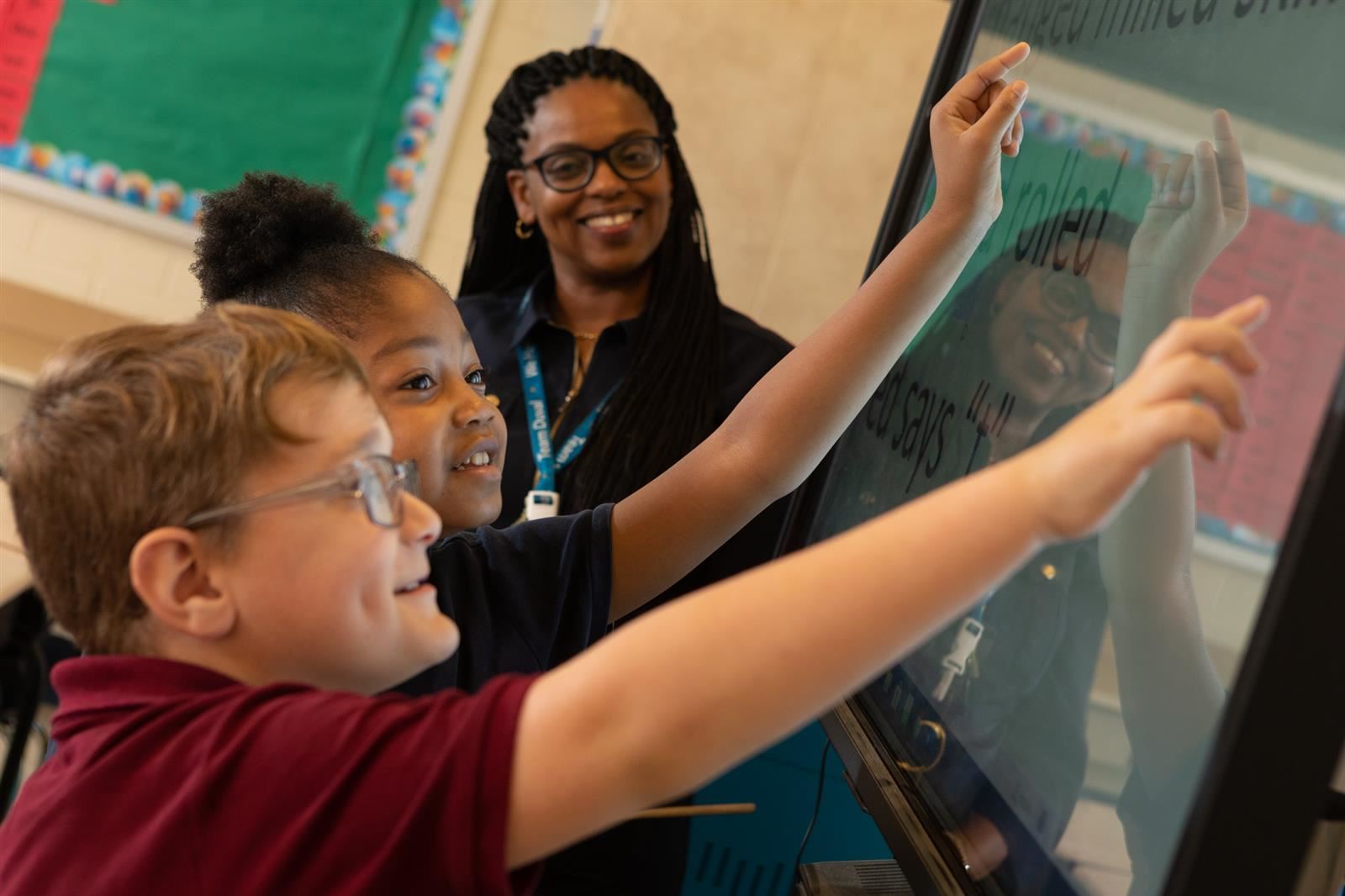 Teacher showing students something in the classroom