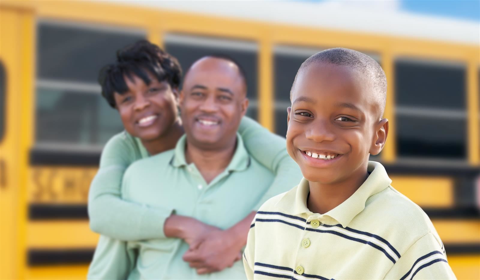 Family in front of a school bus