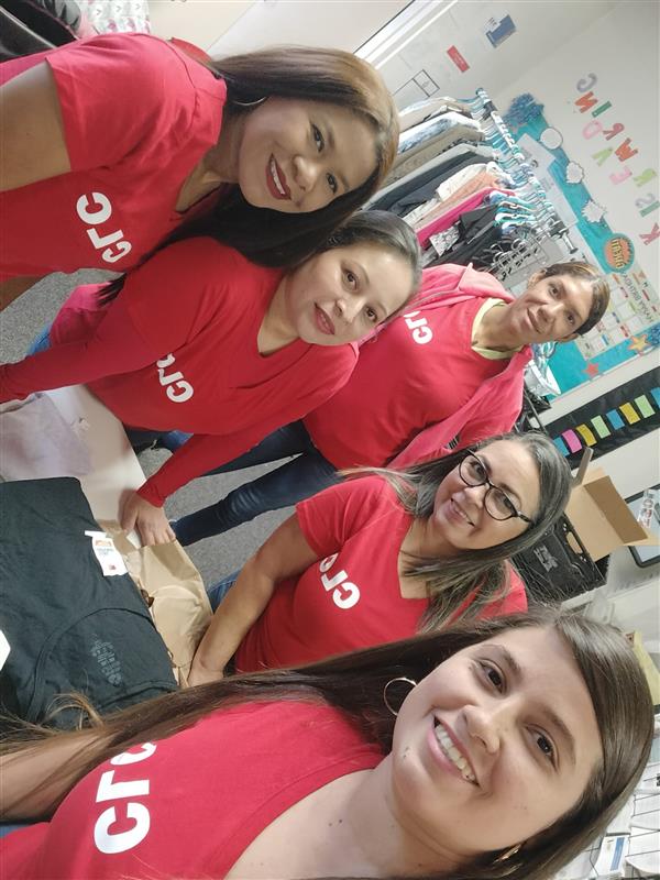 A group of people wearing red t-shirts posing for a picture.