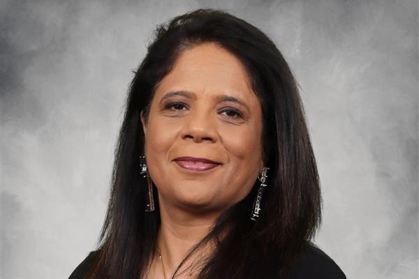 This is a portrait of a woman posing for a photograph, she appears confident with a slight smile.