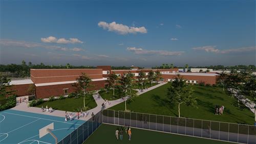 An outdoor basketball court with a fenced perimeter, located on the school premises.