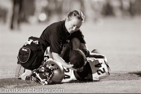 Athletic staff helping a athlete recover