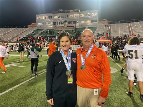 coaches smiling on the field