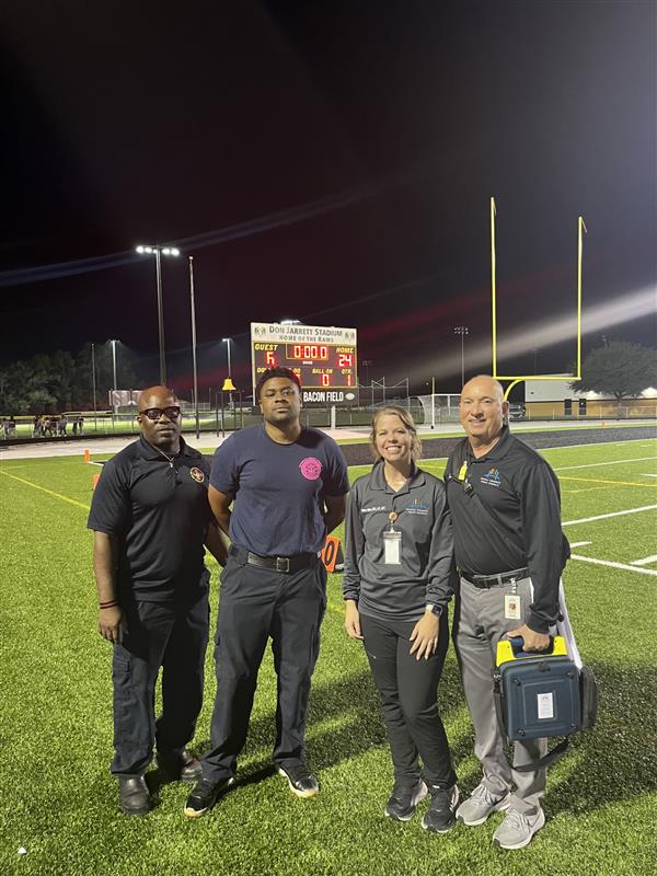 coaches smiling on the field