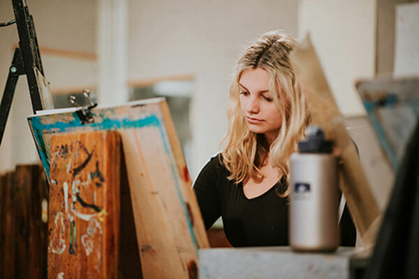 Girl painting on canvas