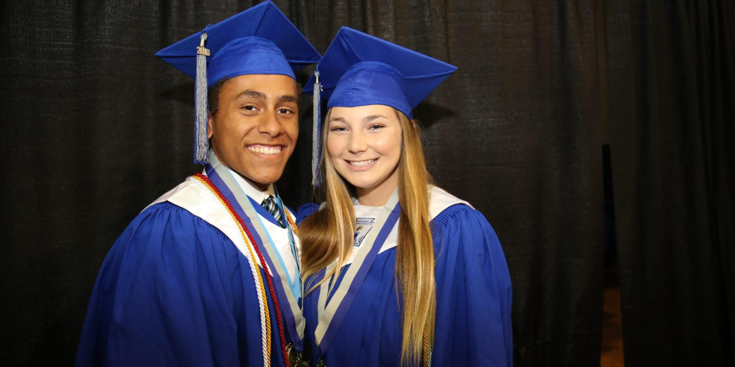 Two grad students smiling