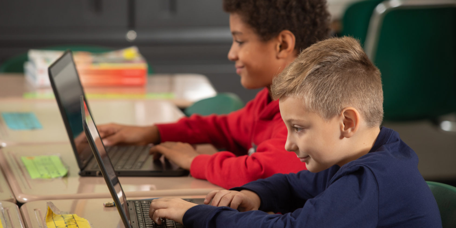 Two students working on their laptops