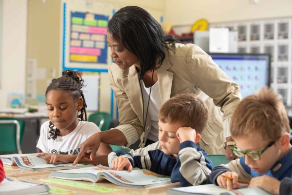 Teacher helping students in class