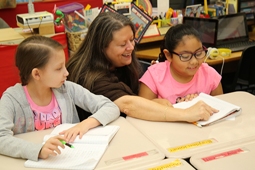 Teacher helping students in class