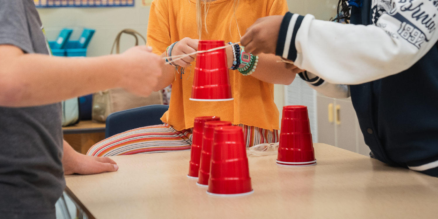 Students making activity with plastic glasses