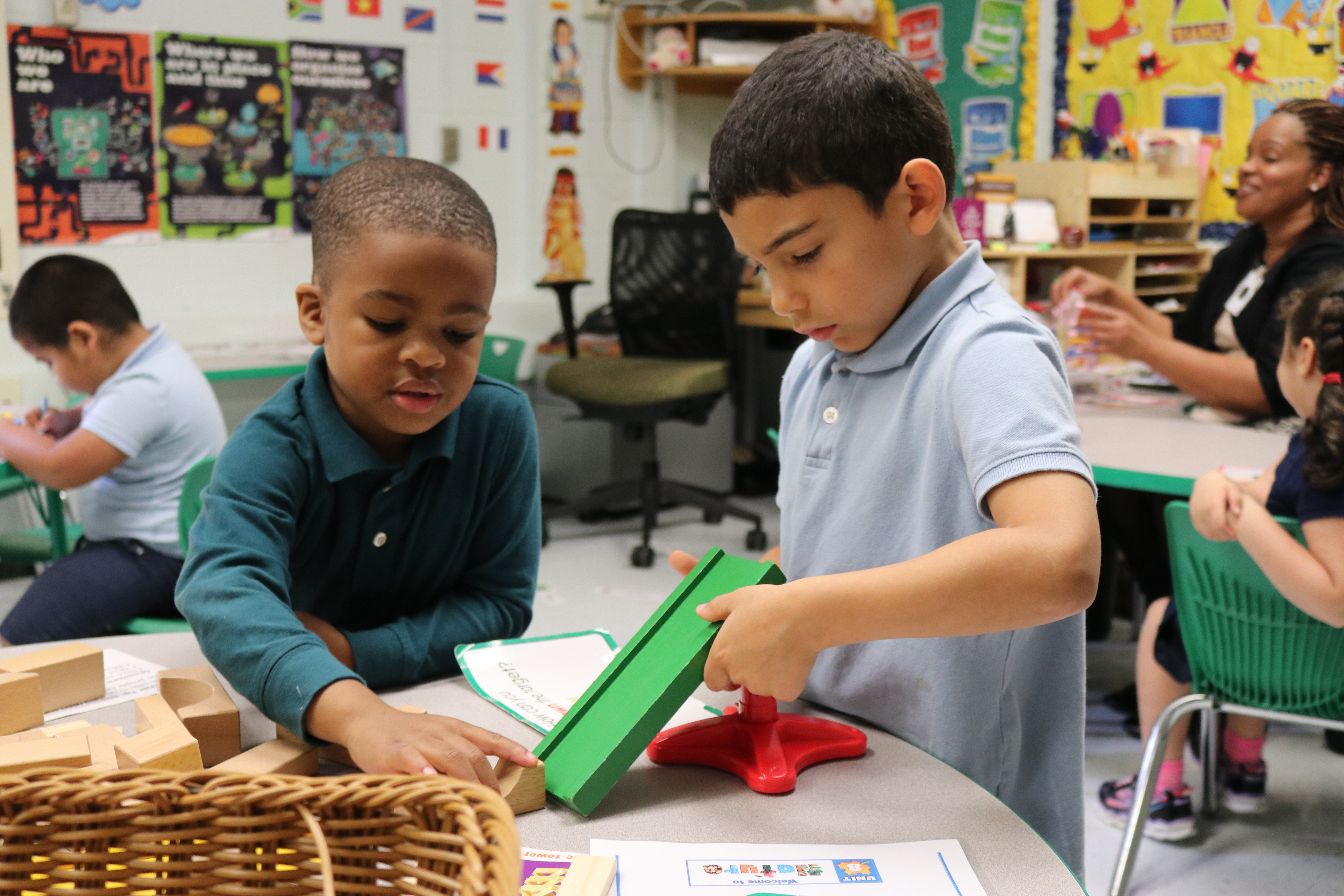 Two prekindergarten students playing with wooden blocks in class