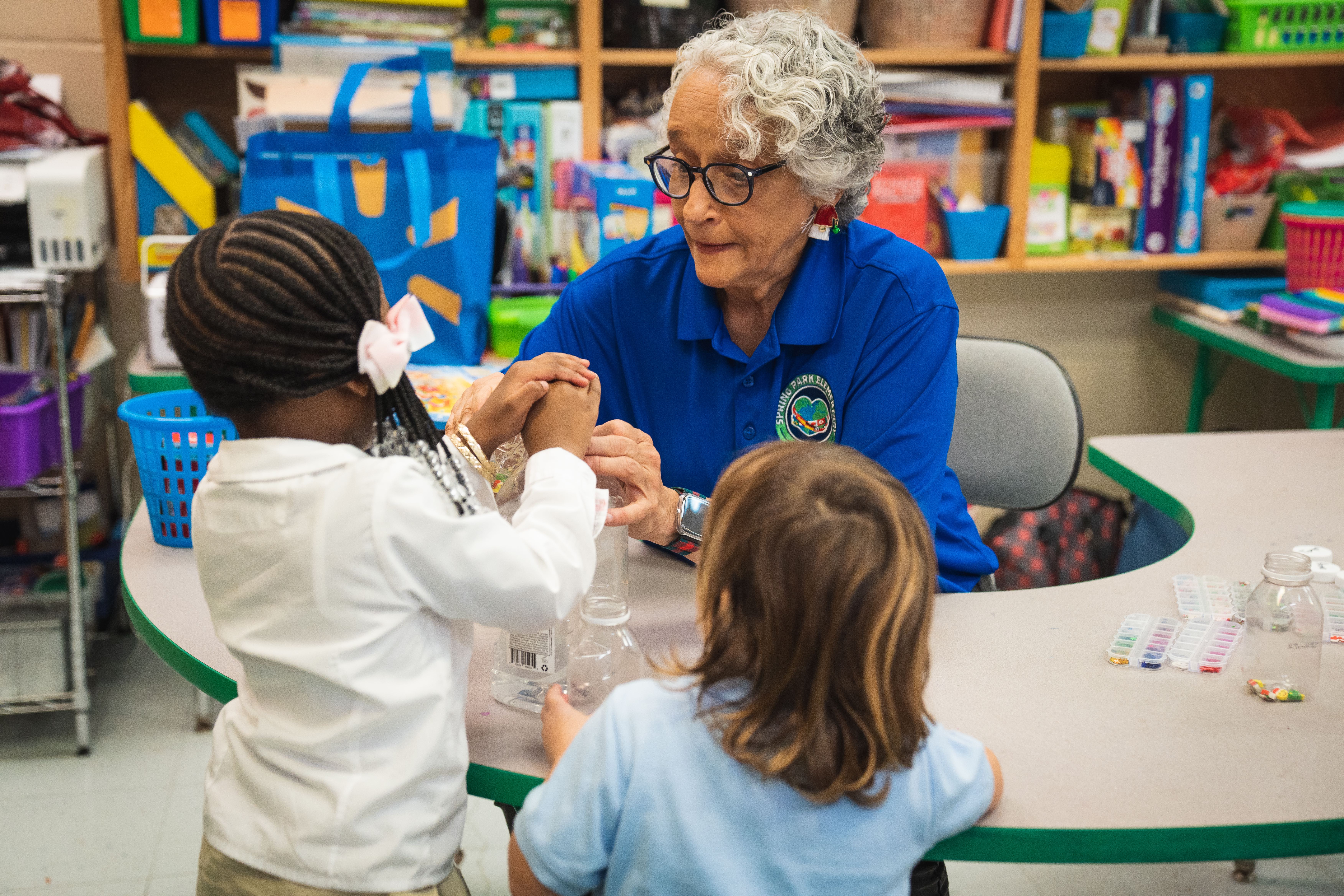 Spring Park Elementary VPK teacher helps two students in a lesson