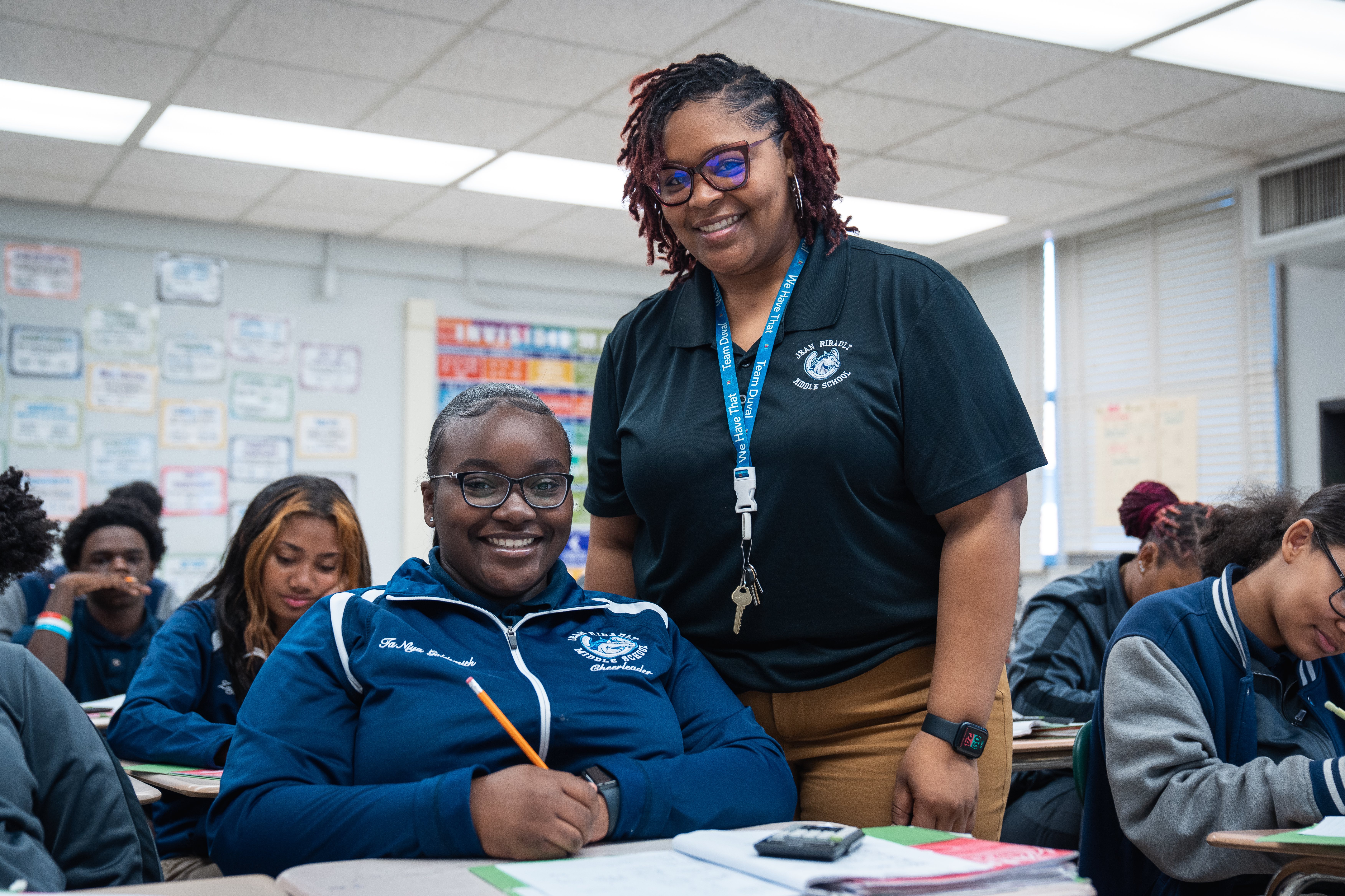 Ribault Middle School teacher and student in an academic classroom smiling