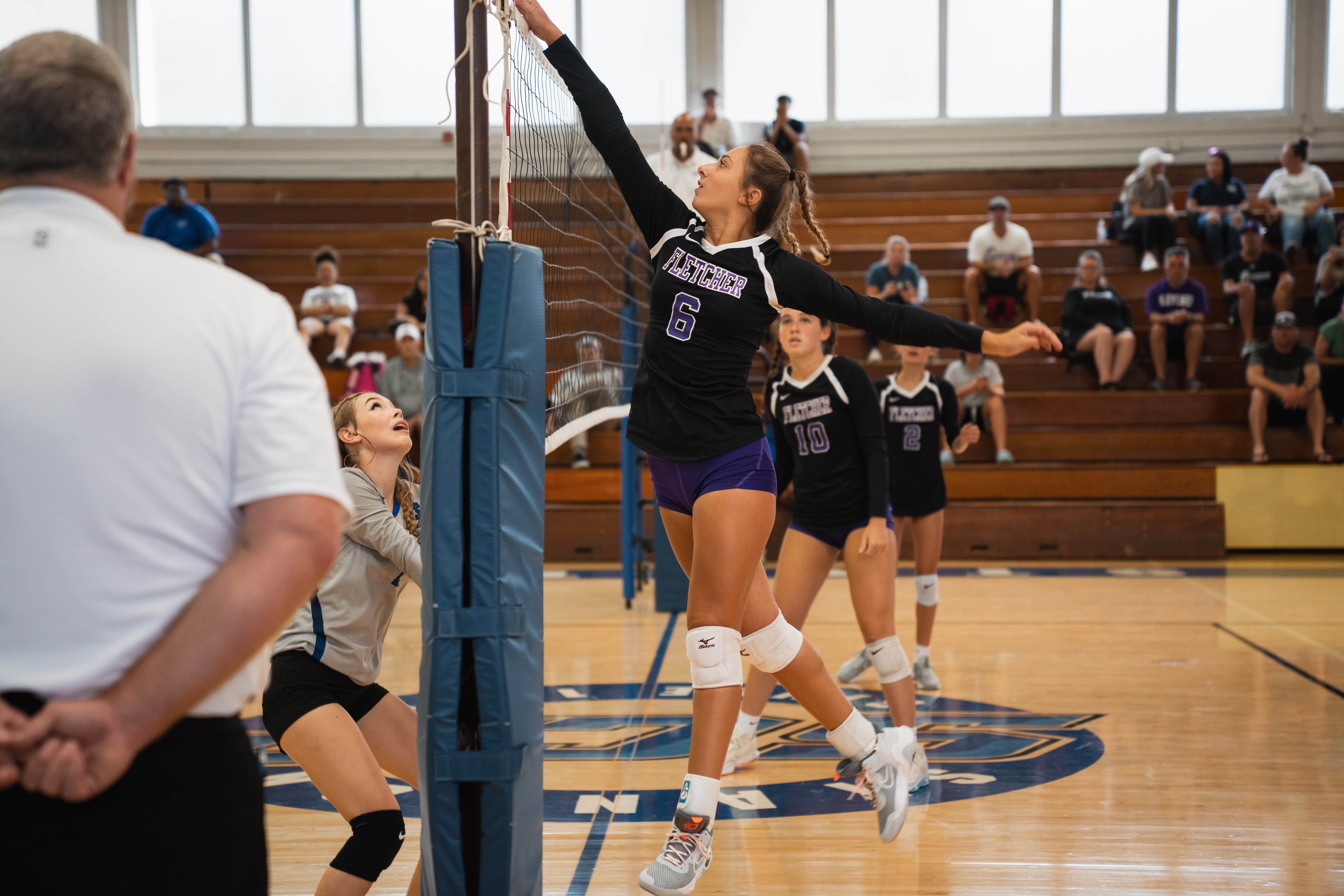 Duval County Public schools student spiking volleyball during game