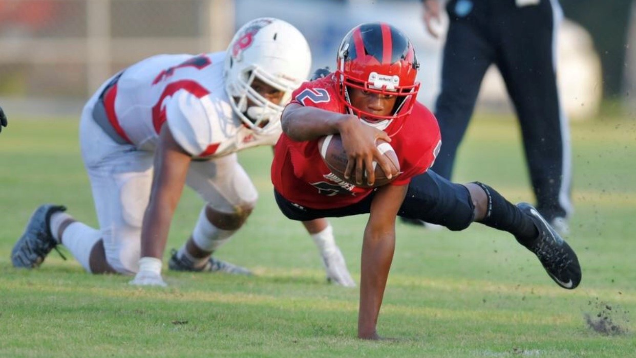 Two football players on the ground at Terry Parker football game