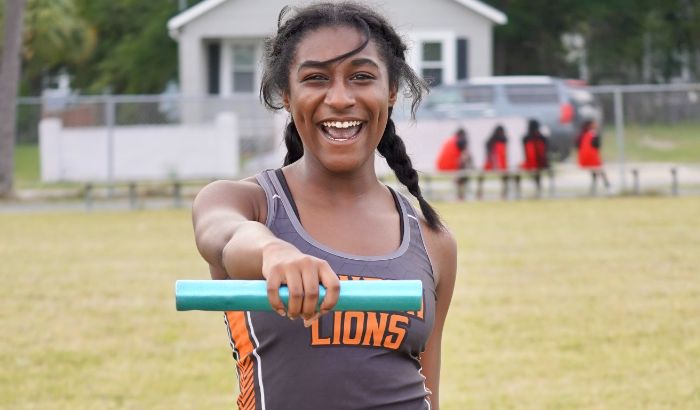 Landon Middle School student-athlete holding a baton