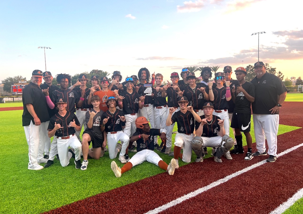 Atlantic Coast High School baseball team on diamond holding Gateway Conference trophy