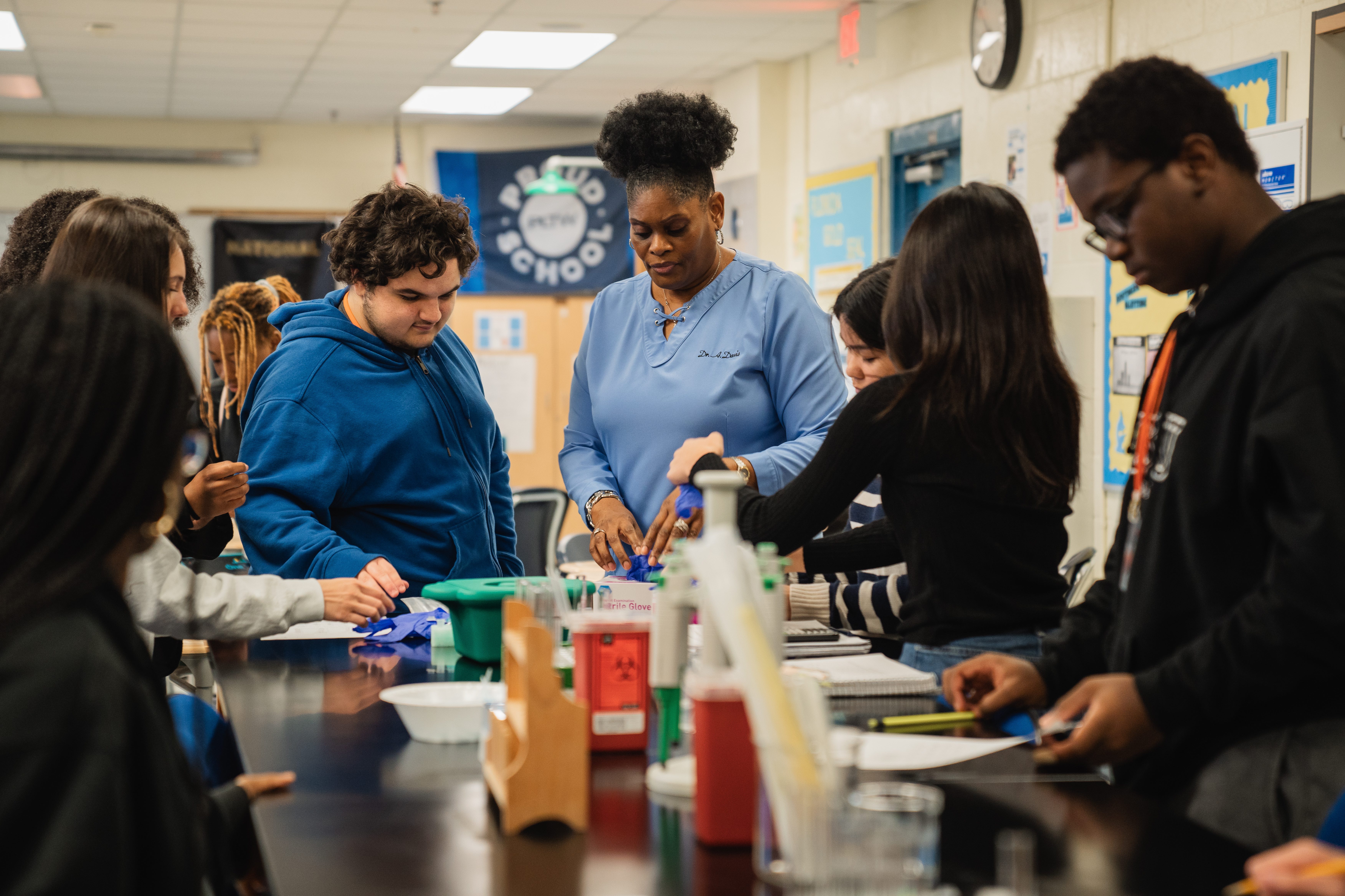 Science teacher at Darnell cookman school of the Medical arts assists students in a lab