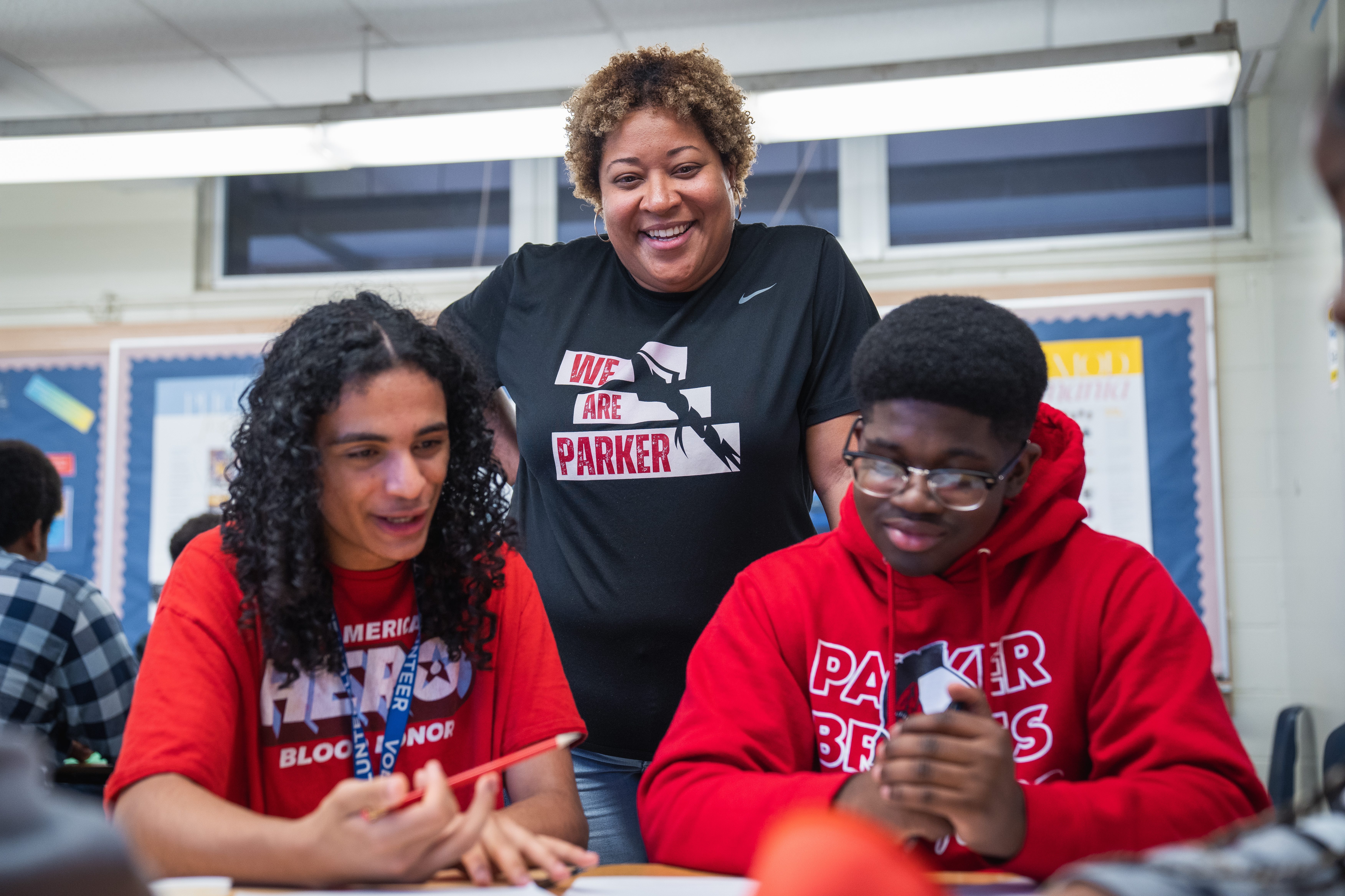 Teacher and two students at Terry Parker High School reviewing an assignment