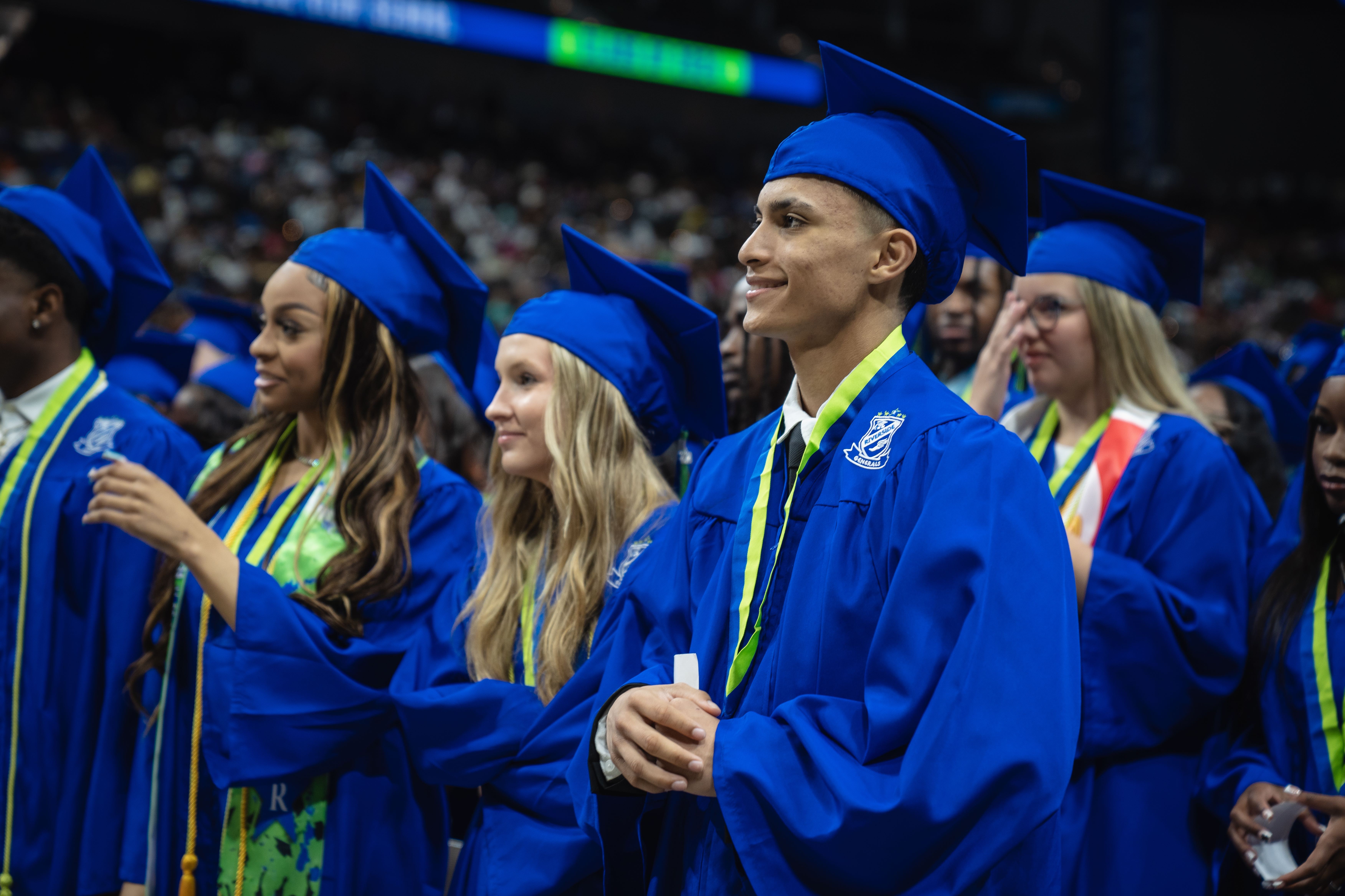 Students smiling and looking forward at a Duval County Public High School graduation ceremony