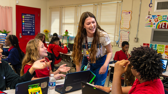 Inside of middle schools in Duval County.  A teacher speaks to a group of students at their desks