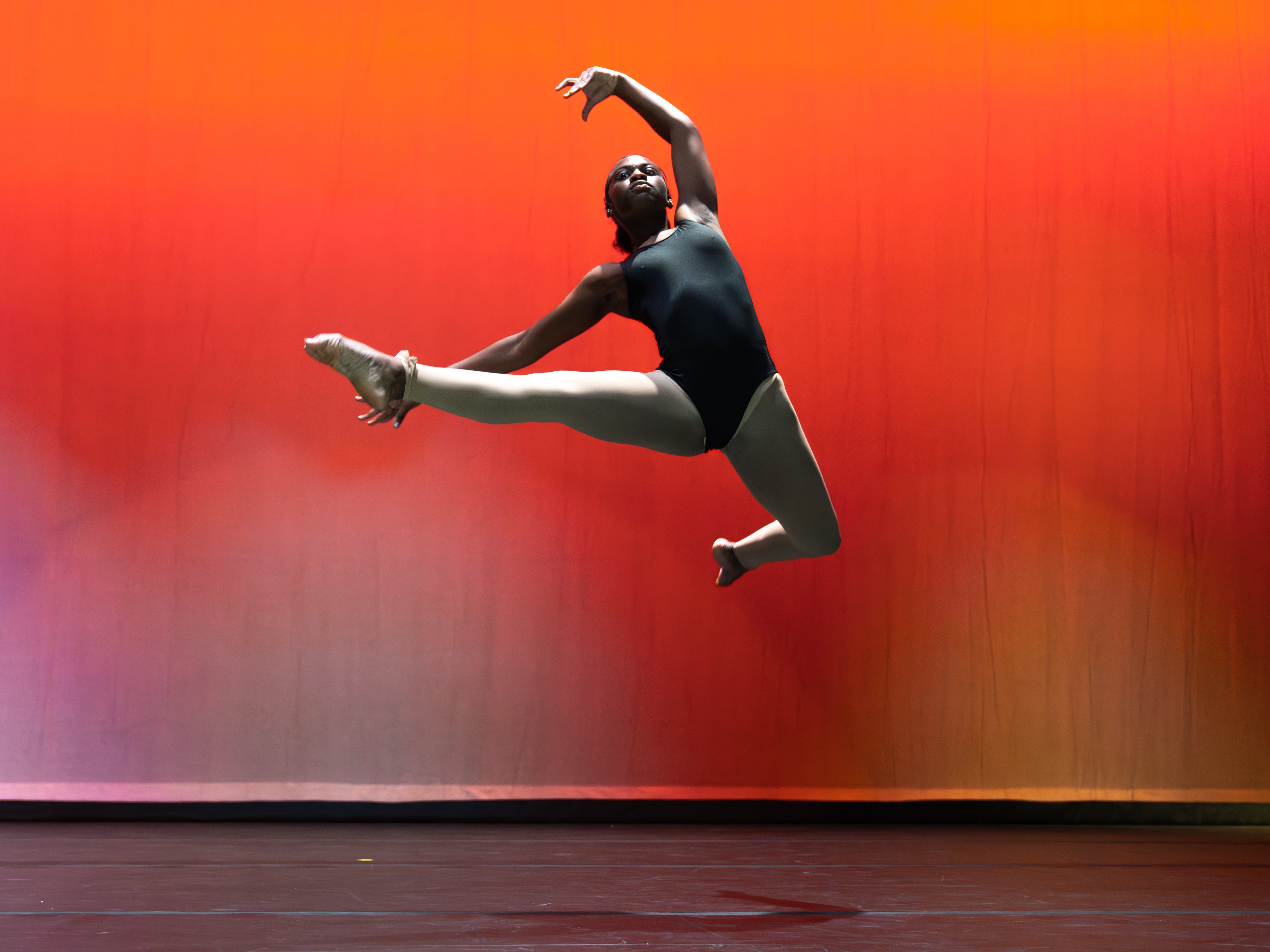 Fort Caroline Middle School dancer leaping in the air on stage