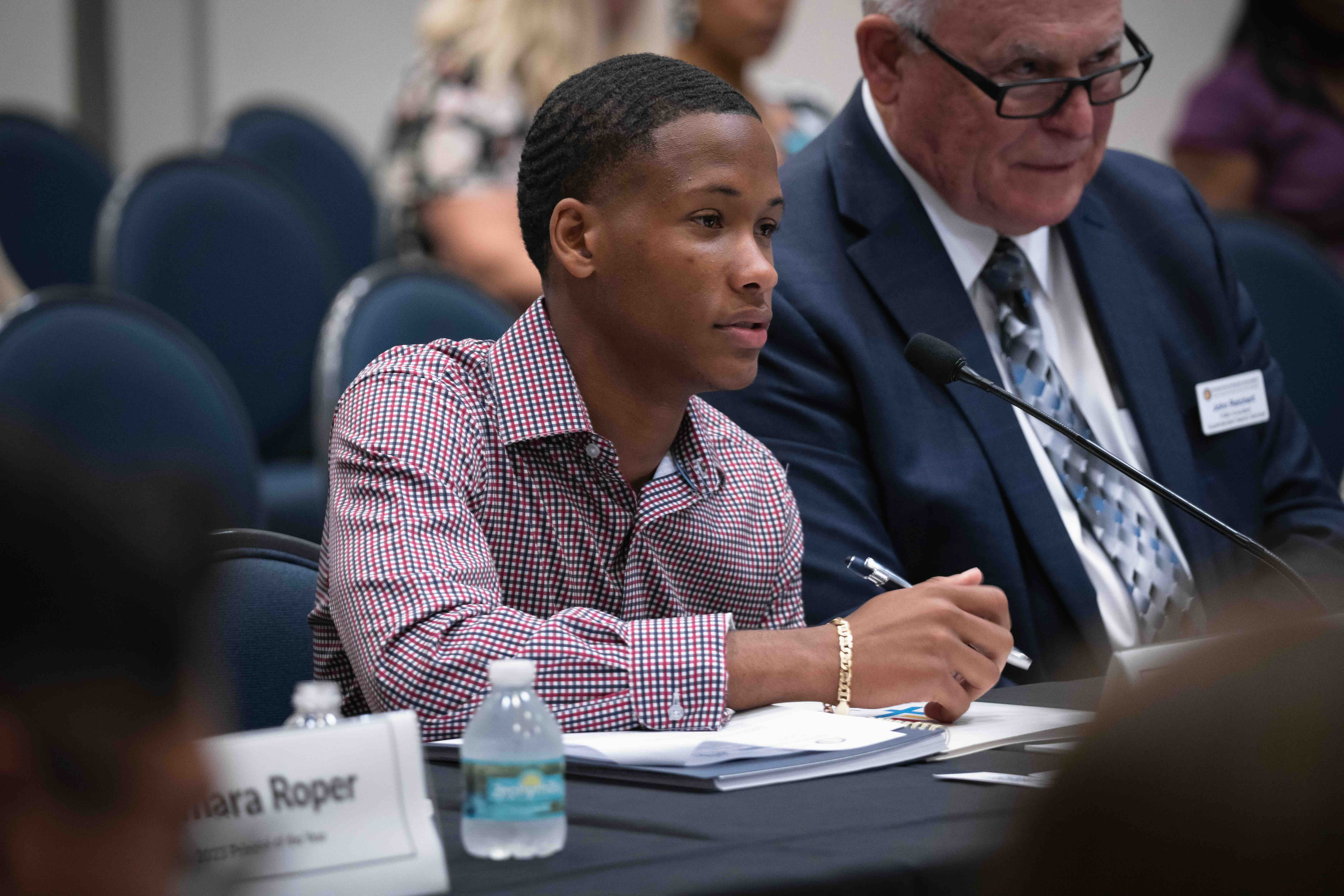 Student speaking into a microphone