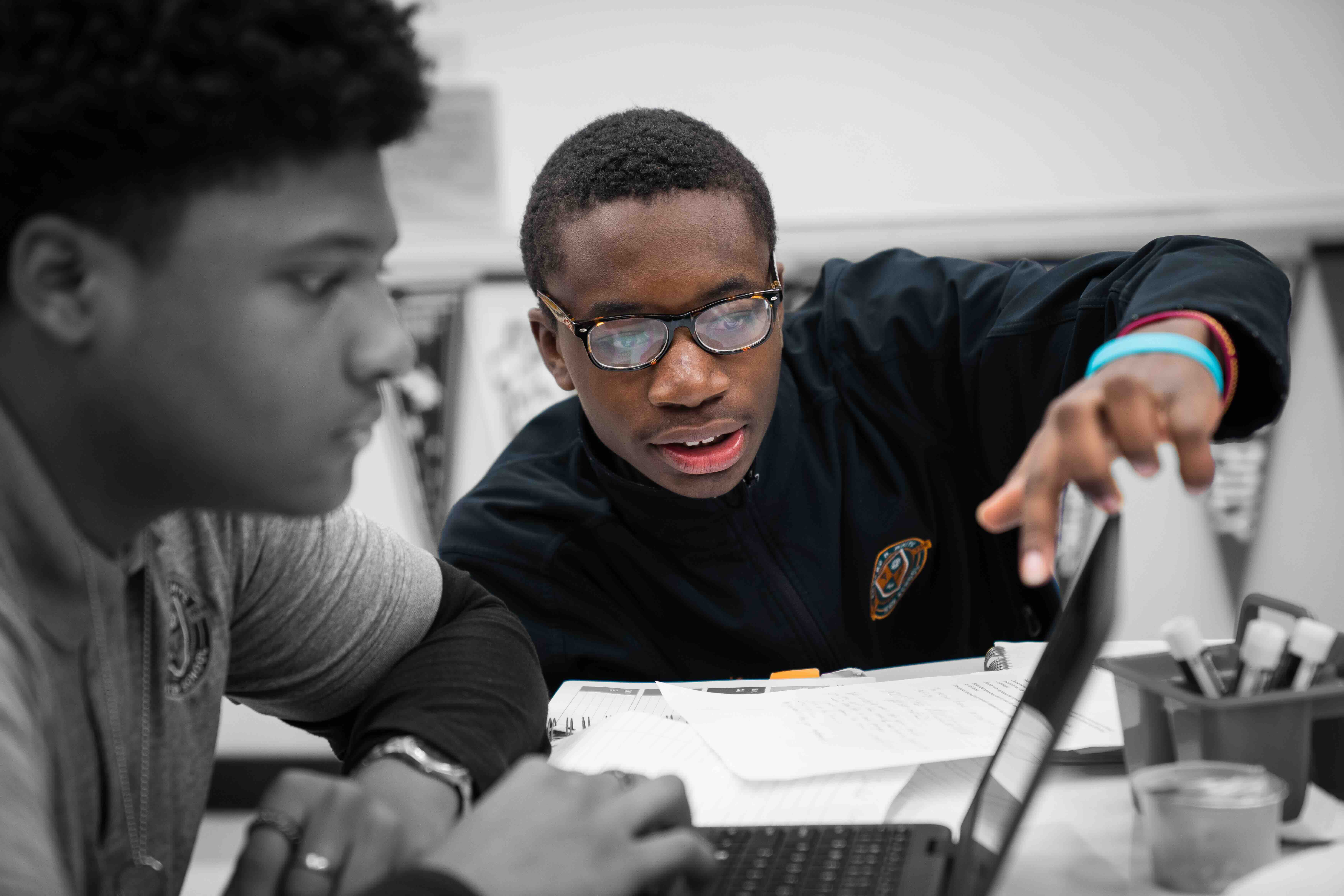 Student working with other student in a computer