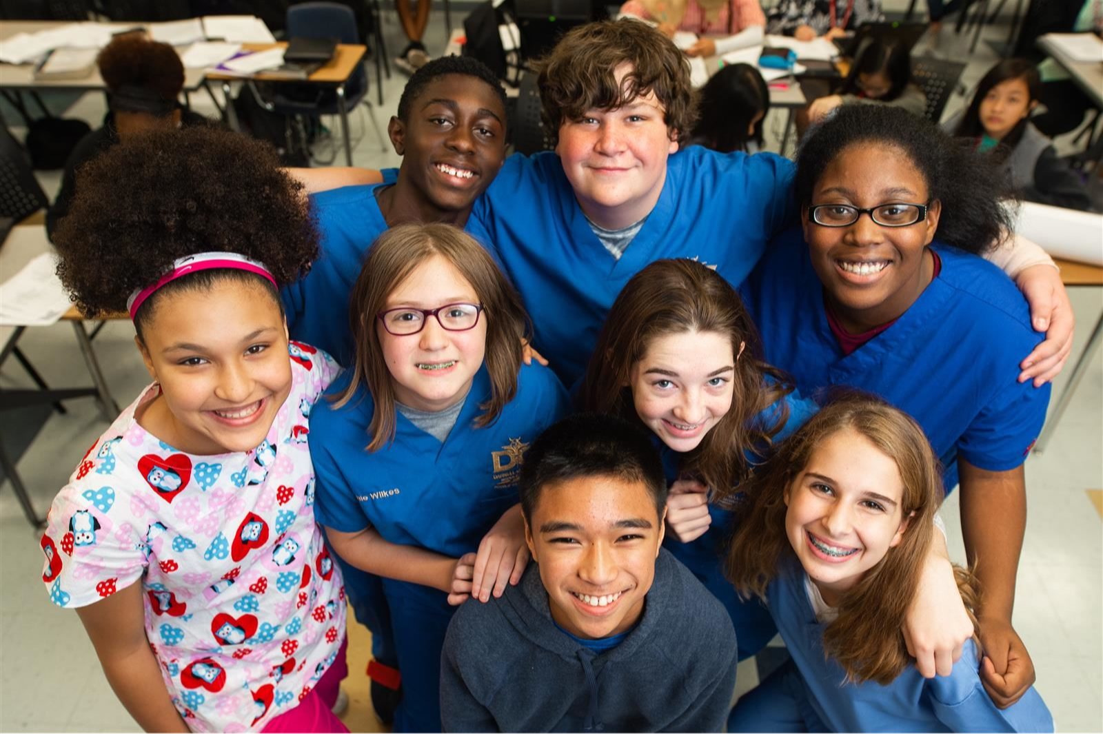 Students and teacher smiling