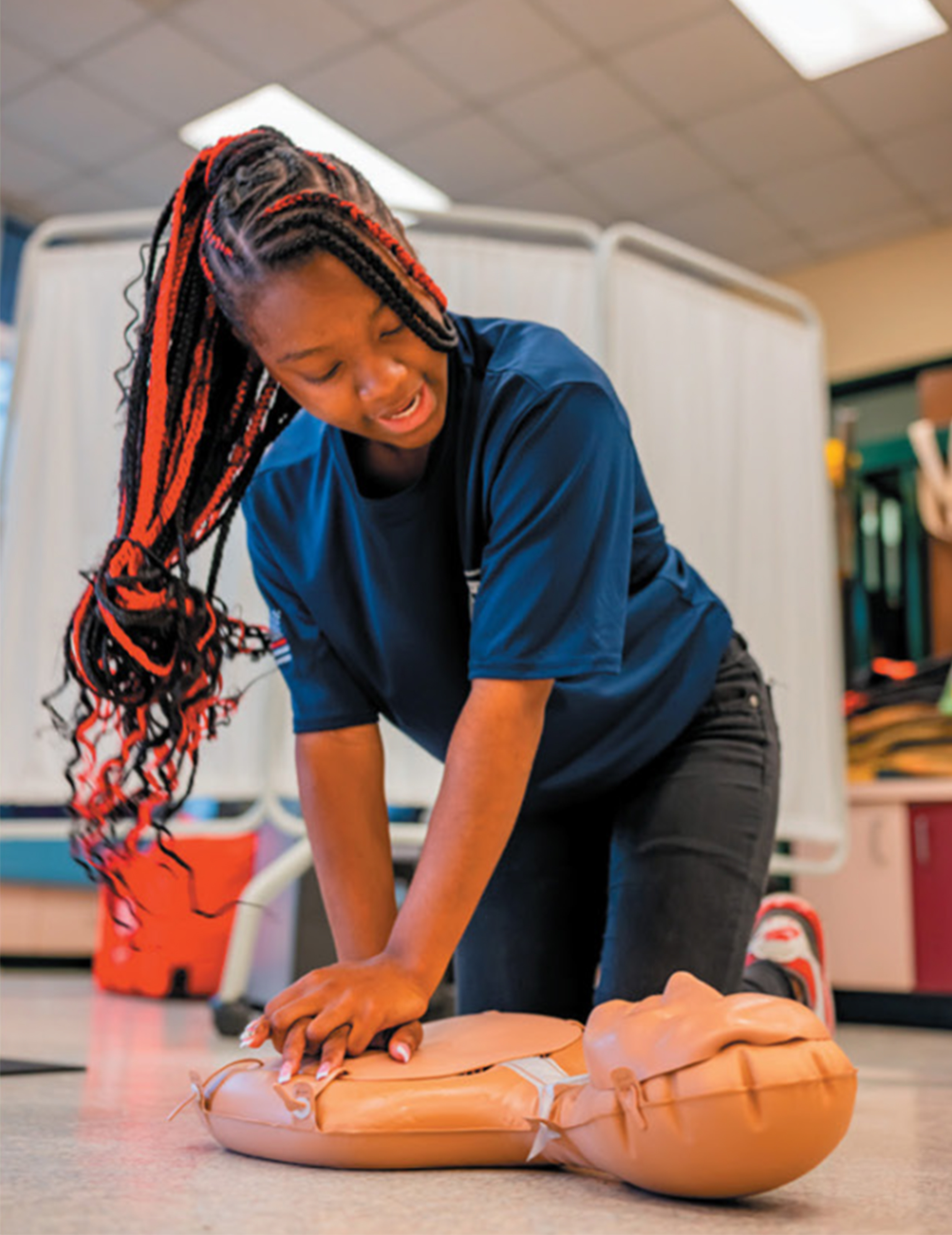 student performing CPR on Mannequin